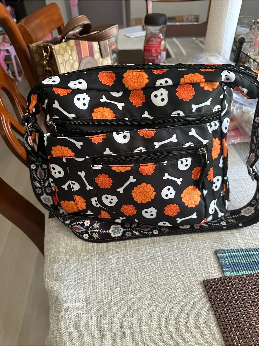 Halloween-themed crossbody bag featuring a skull and marigold print